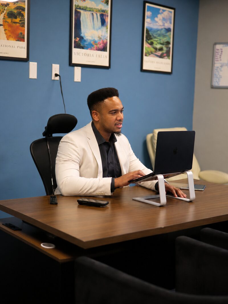 A NoeCee Global team member preparing for the day at a desk in the Fairfax office