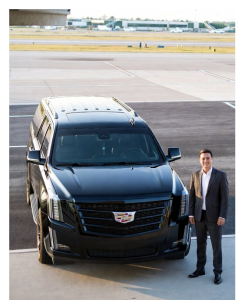 Cadillac Escalade at the airport curb for a meet-and-greet airport transfer