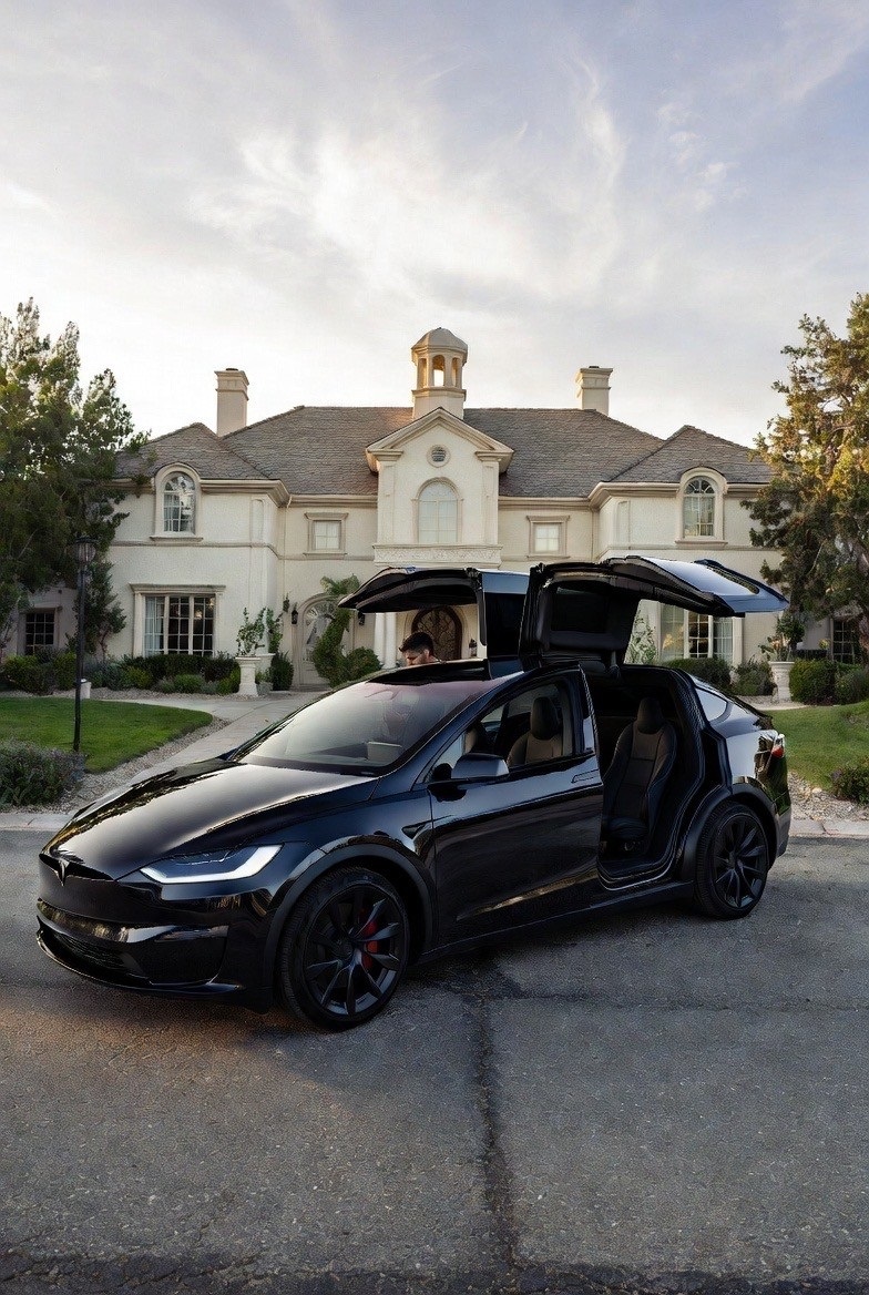 Tesla Model X picking up a passenger in a Las Vegas residential neighborhood