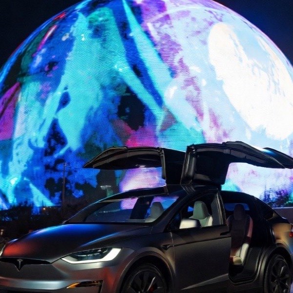 Tesla Model X with its falcon-wing doors open in front of the Sphere in Las Vegas
