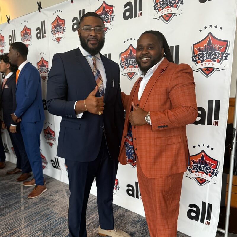 Two Onias Marketing leaders in tailored suits at a recognition event
