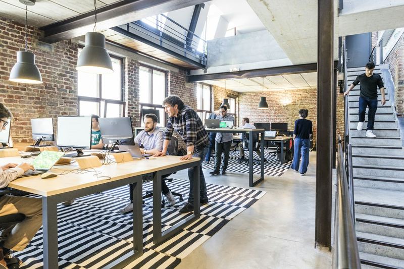 Open office with recruiters working at long desks