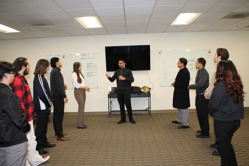 A Sora Acquisitions team meeting with representatives listening to a presenter