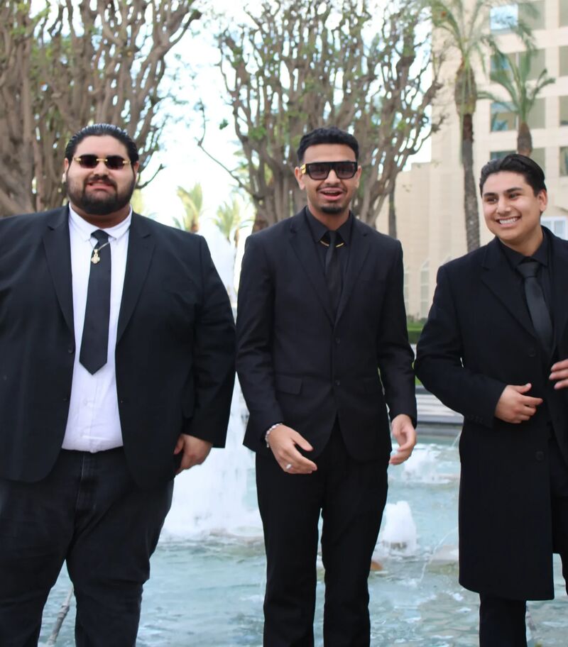 Three Sora Acquisitions representatives in dark suits outdoors