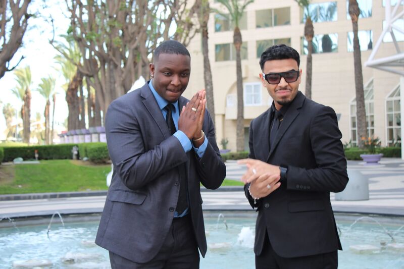 Two Sora Acquisitions representatives in suits greeting each other outdoors
