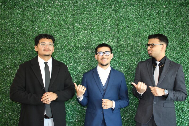 Three Sora Acquisitions representatives in suits in front of a green wall