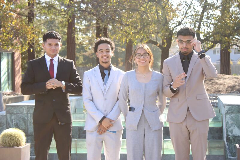 Sora Acquisitions team members in suits standing outdoors