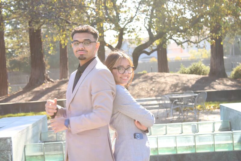 Two Sora Acquisitions associates in light suits outdoors