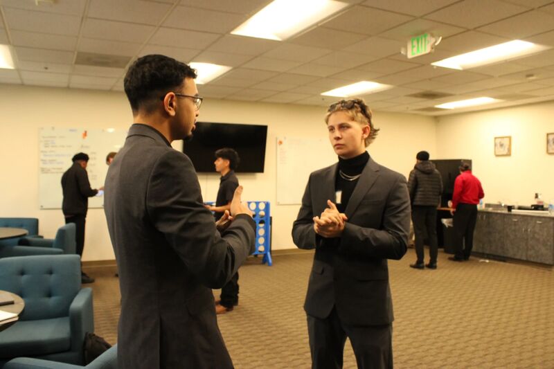 Two Sora Acquisitions representatives talking in the office