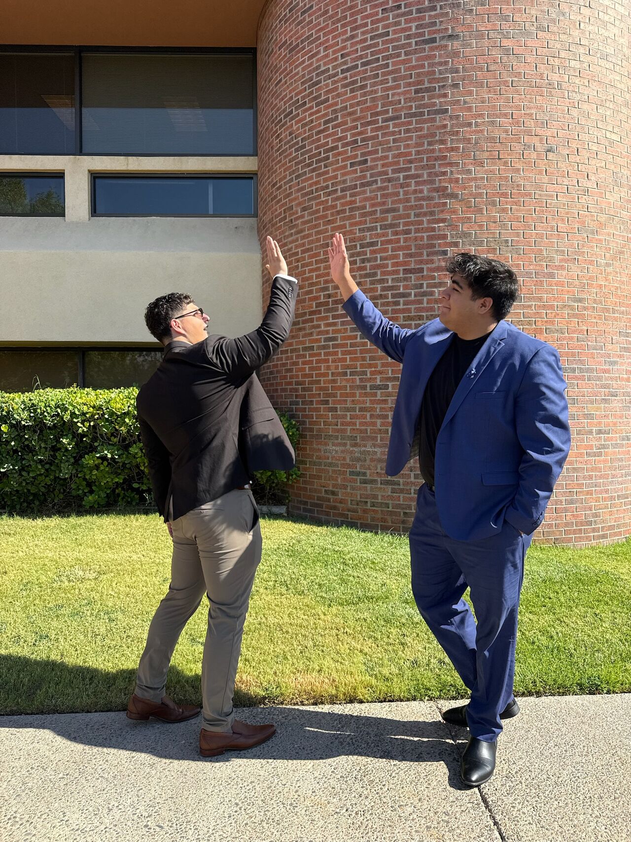 Two Super Nova Marketing colleagues giving each other a high five outside the office