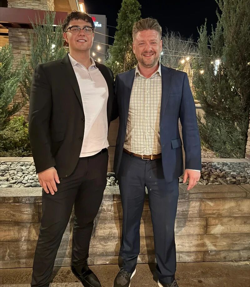 Two Super Nova Marketing team members standing together outside at dusk
