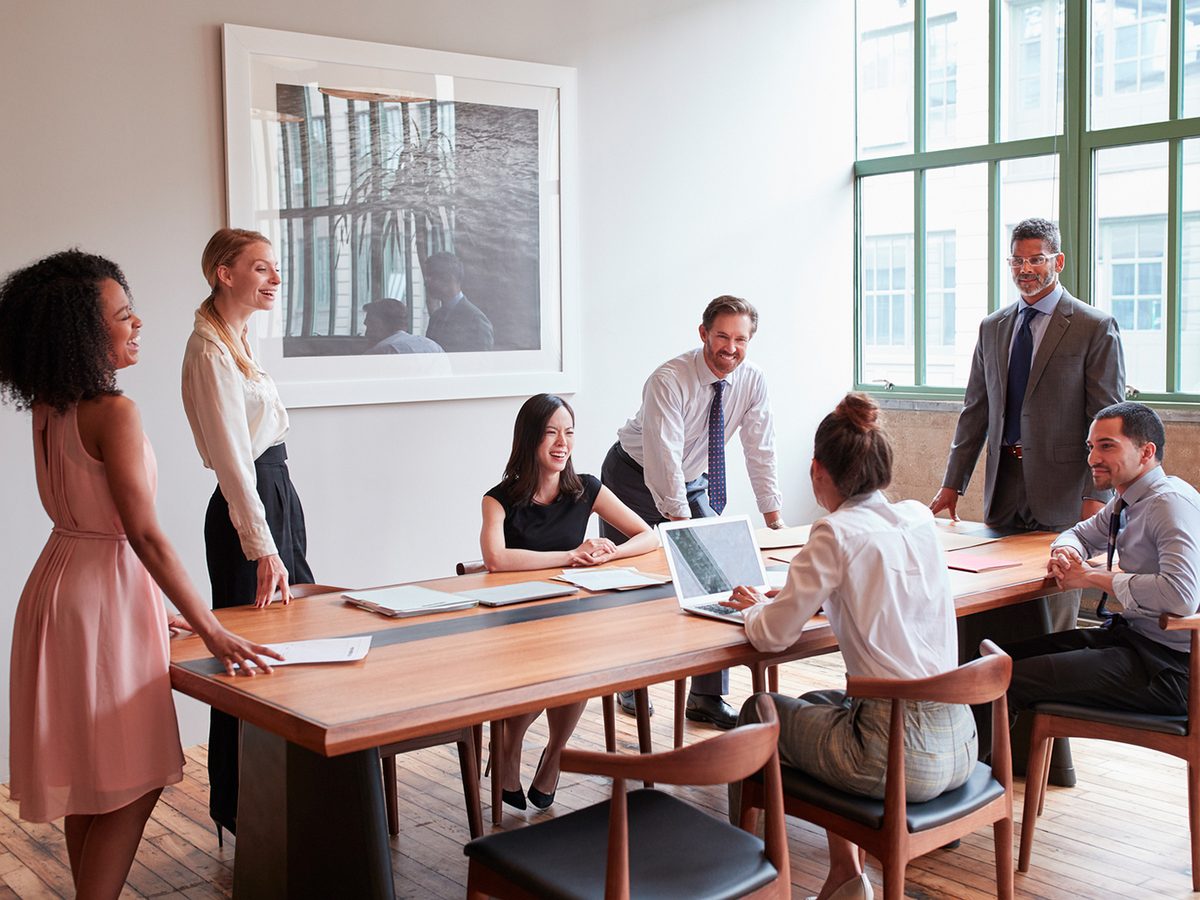 A sales and marketing strategy meeting around a boardroom table