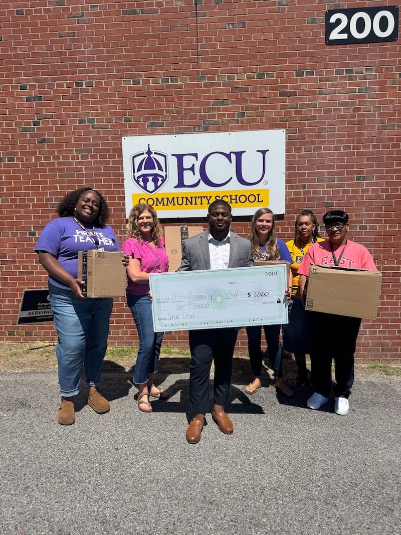 The Vendex team presenting a donation cheque to ECU Community School