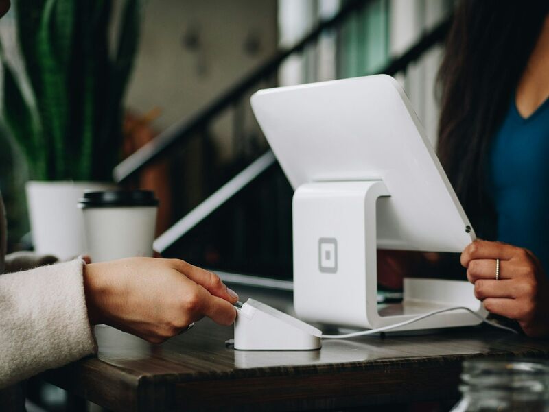 A sales professional completing a face-to-face customer transaction