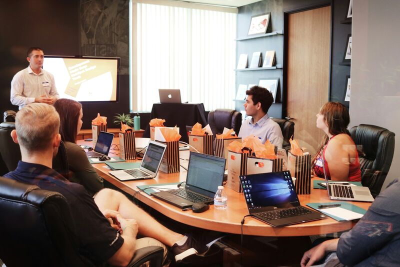 A sales trainer leading a professional development session for a group of team members