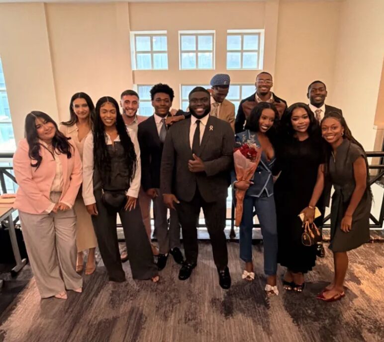 WC Acquisitions team members dressed professionally and celebrating together at a company event
